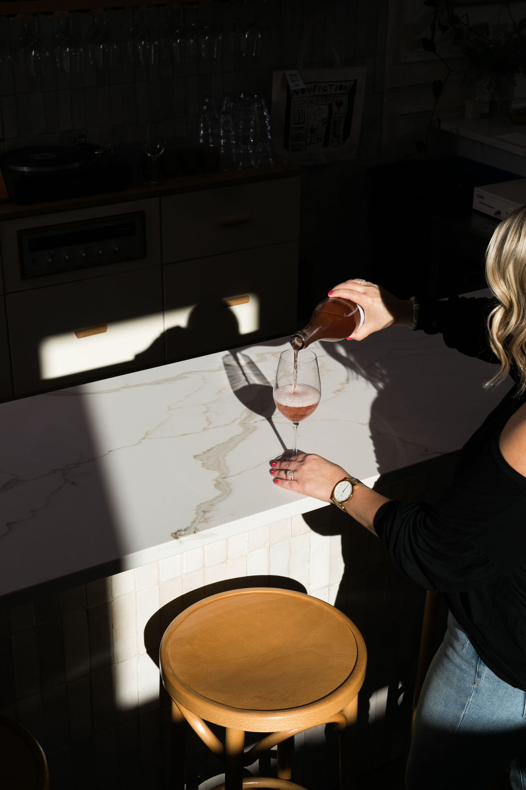 Chelsea pouring wine into a glass