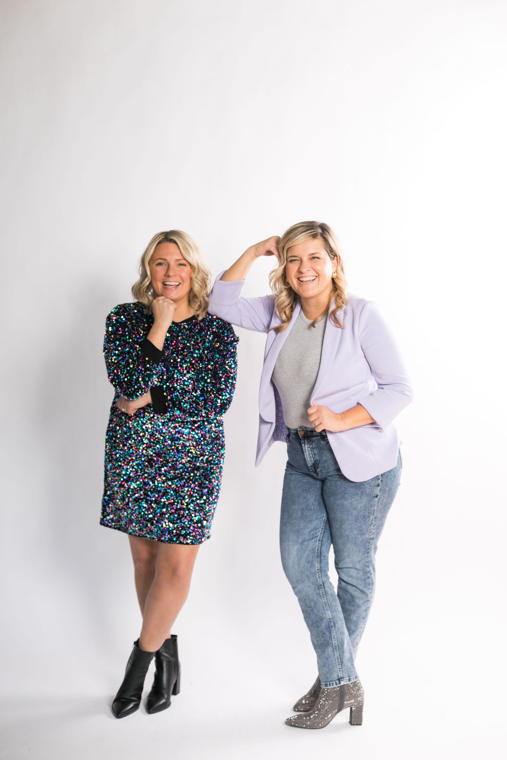A picture of Chelsea and Kayla standing next to each other, smiling and posing