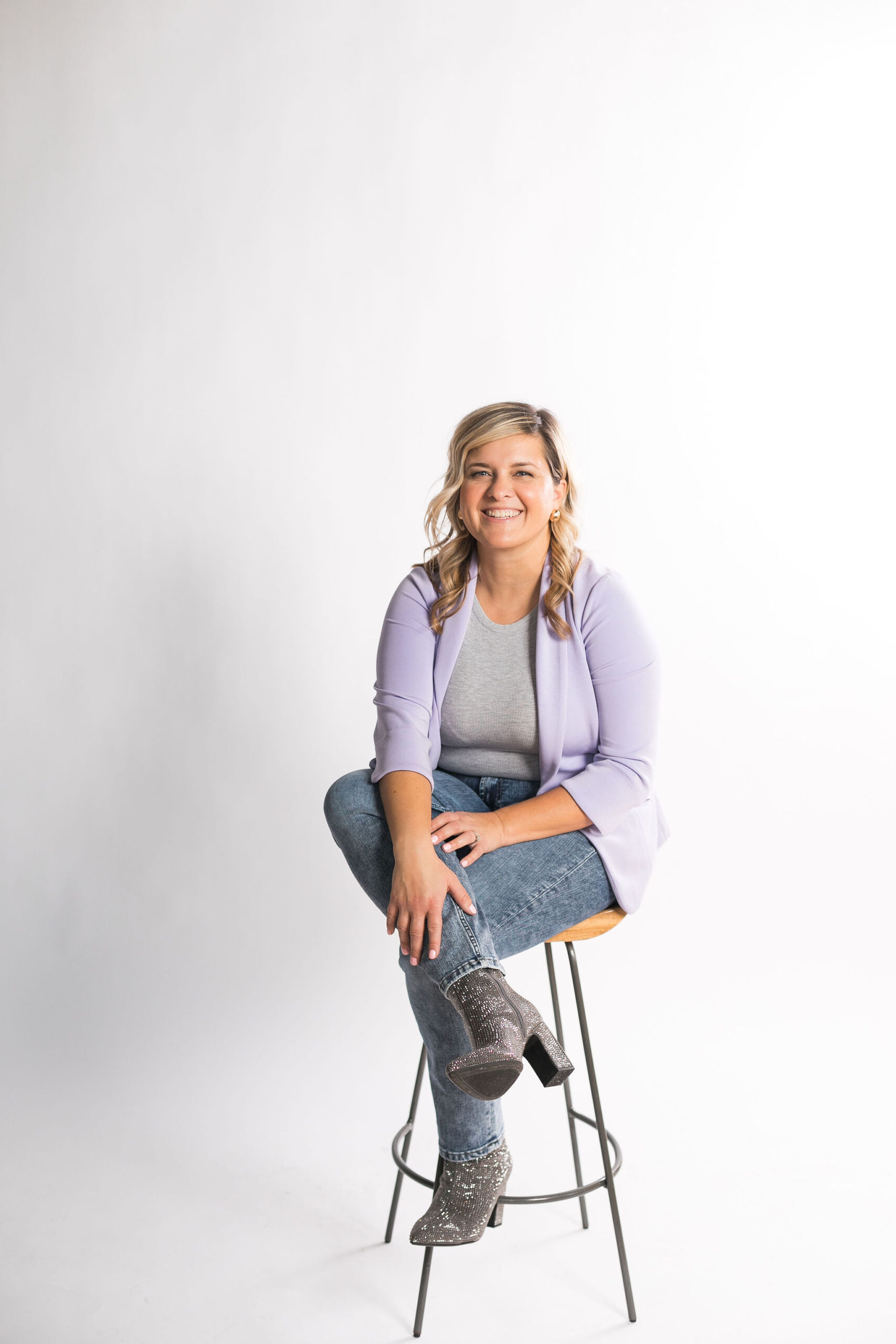 Kayla smiling and sitting on a booth