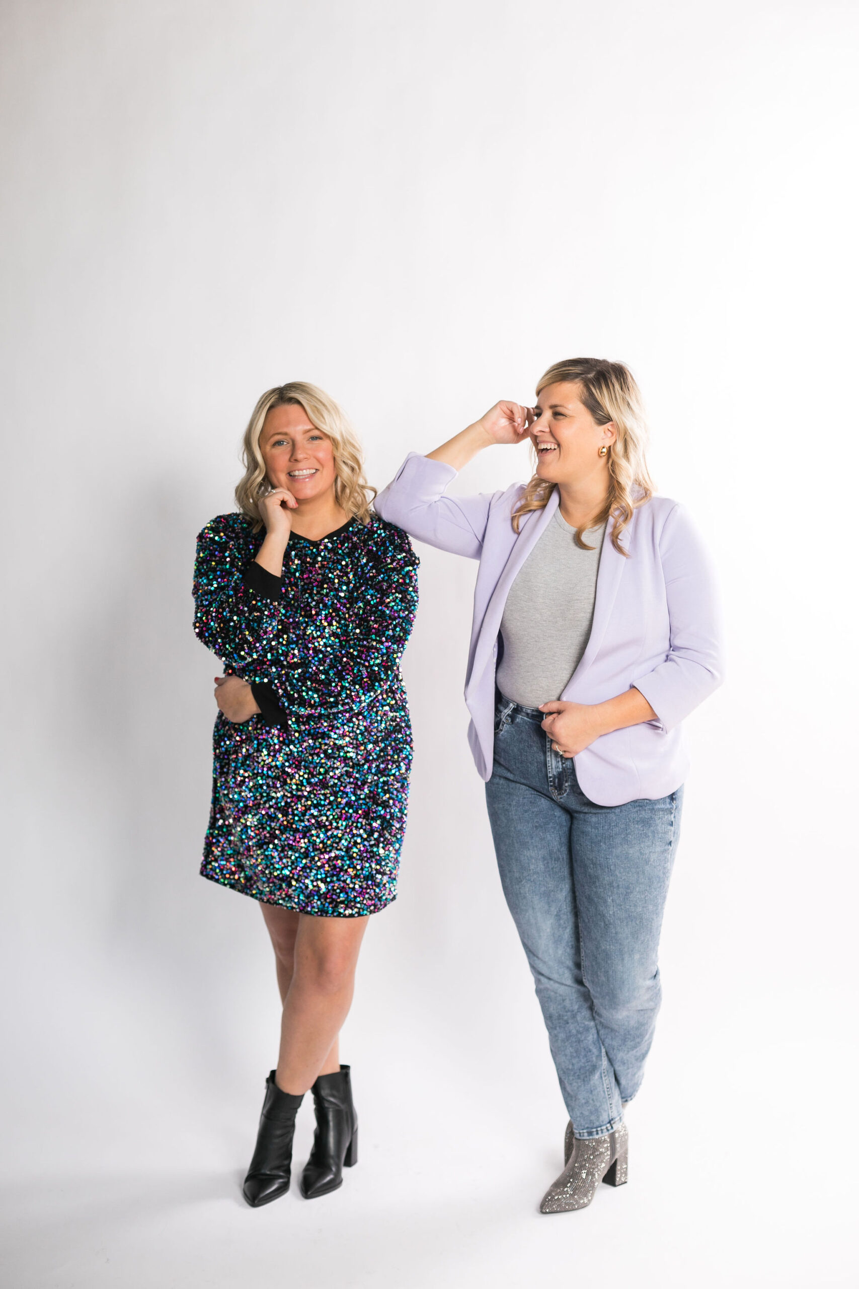 Chelsea and Kayla standing next to each other, posing together, and smiling